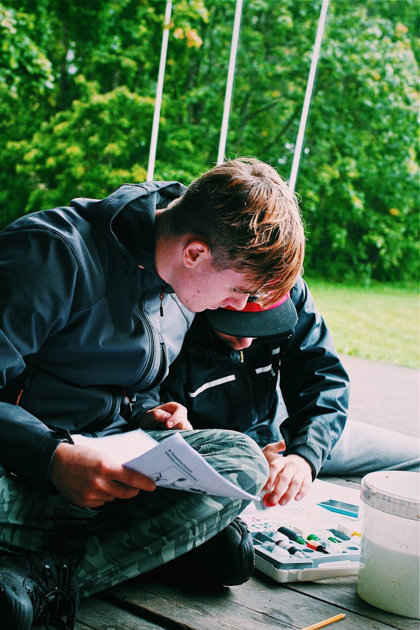 Study Abroad A man and child enjoy outdoor painting together during summer.